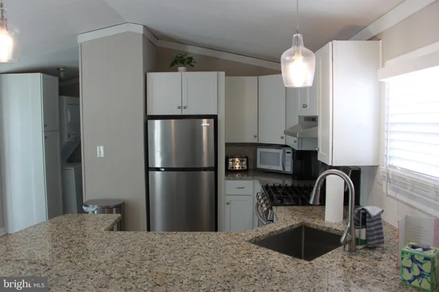 a kitchen with a refrigerator and a sink