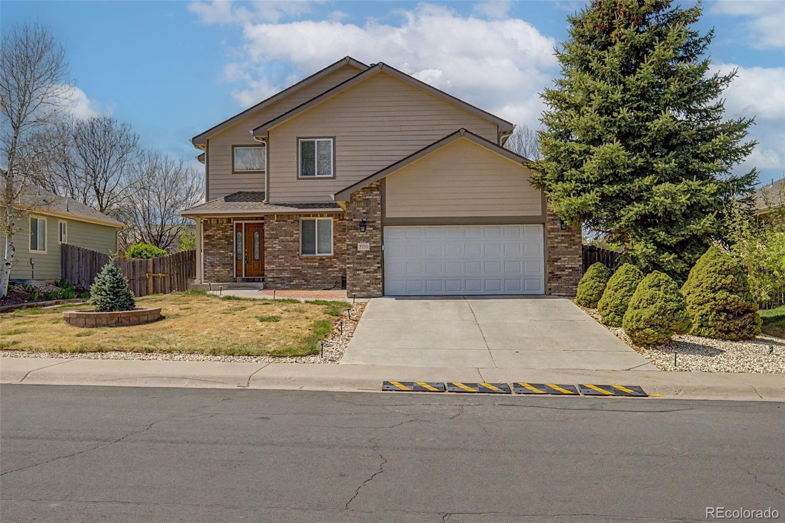 2233 70th Avenue Greeley, CO 80634 - Photo 1 of 50 a view of garage yard and tree