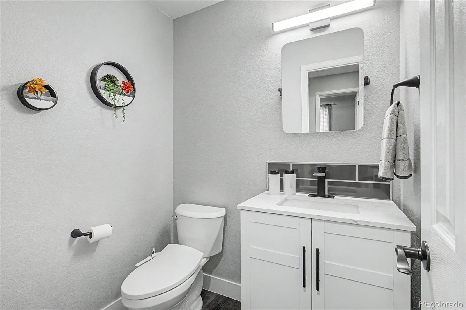 2233 70th Avenue Greeley, CO 80634 - Photo 13 of 50 a bathroom with a toilet sink vanity and vanity