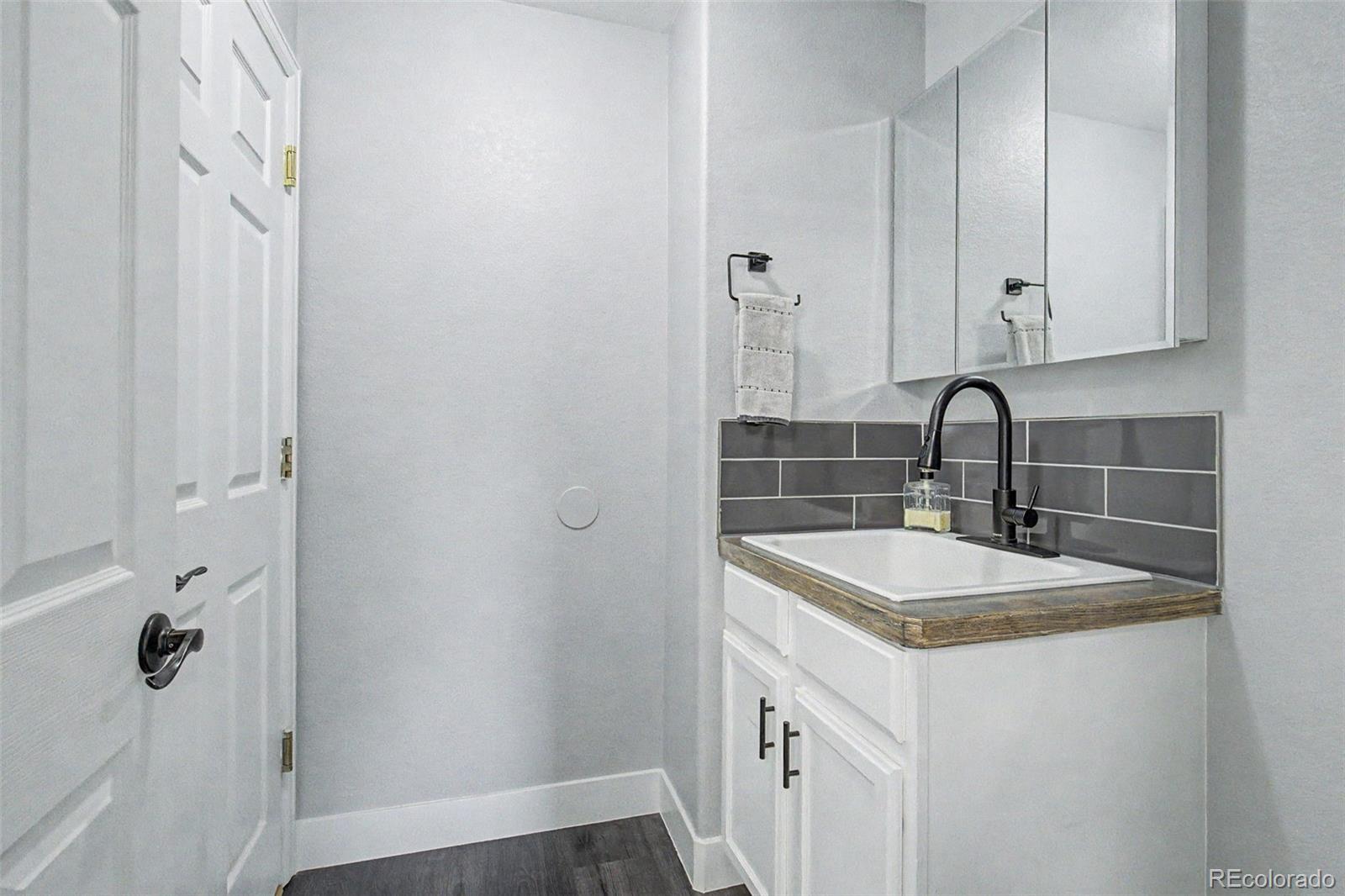 2233 70th Avenue Greeley, CO 80634 - Photo 14 of 50 a bathroom with a sink and a mirror