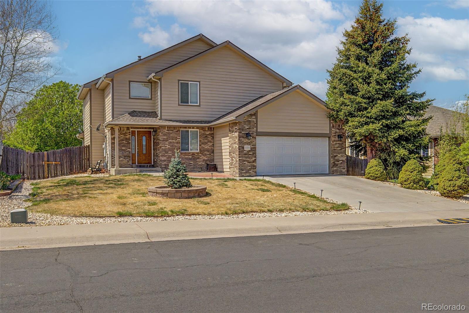2233 70th Avenue Greeley, CO 80634 - Photo 2 of 50 a front view of a house with a yard and garage
