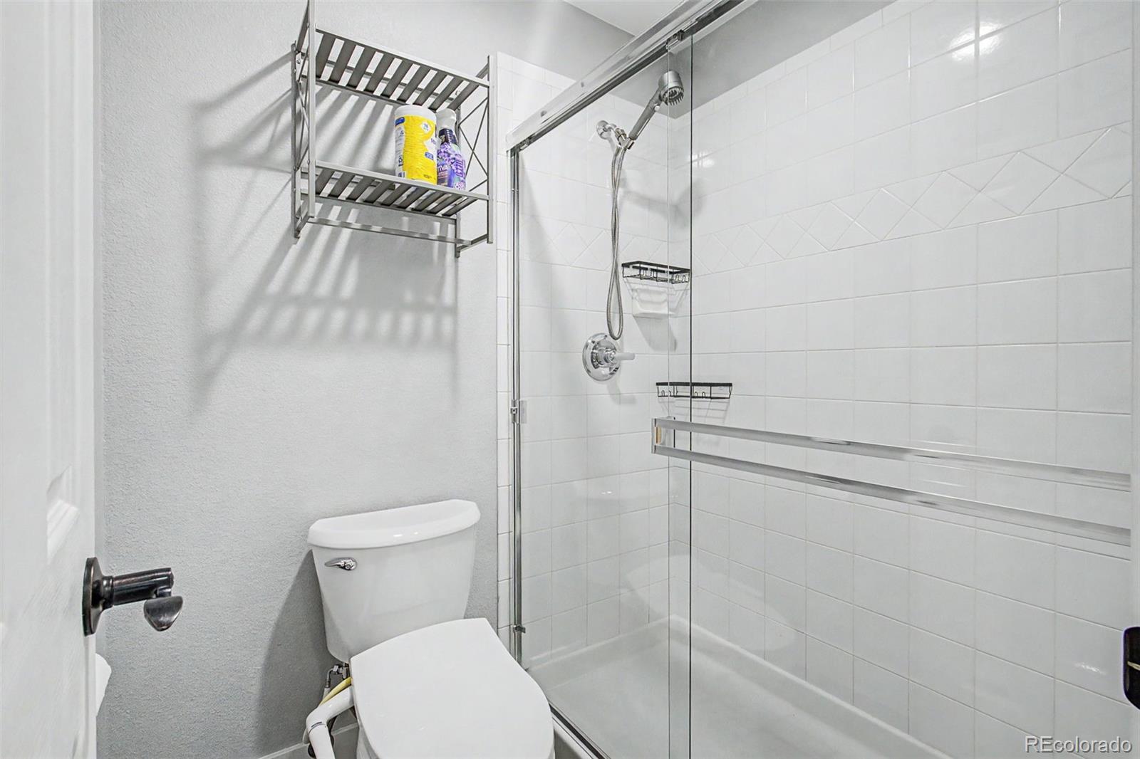 2233 70th Avenue Greeley, CO 80634 - Photo 25 of 50 a bathroom with a toilet and a shower