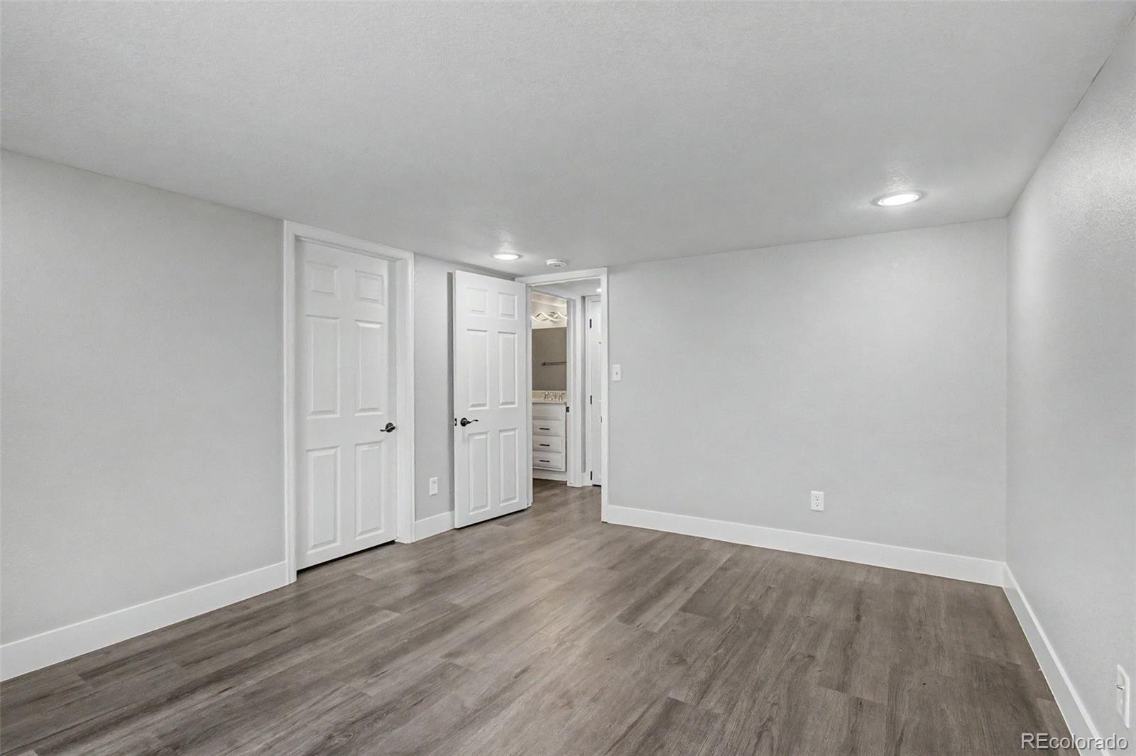 2233 70th Avenue Greeley, CO 80634 - Photo 37 of 50 a view of an empty room with wooden floor