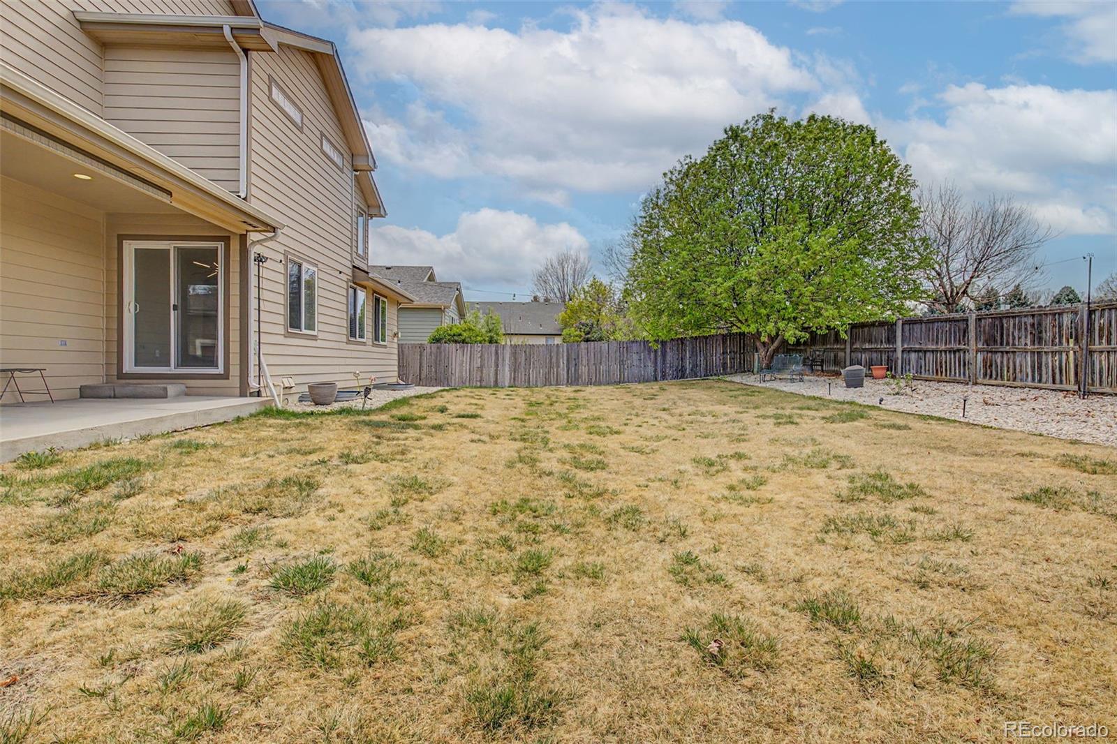 2233 70th Avenue Greeley, CO 80634 - Photo 49 of 50 a swimming pool with some trees in the background