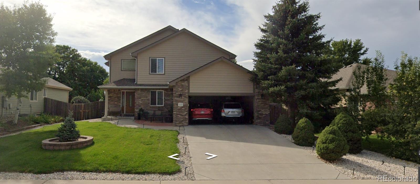 2233 70th Avenue Greeley, CO 80634 - Photo 50 of 50 a front view of a house with a garden and plants
