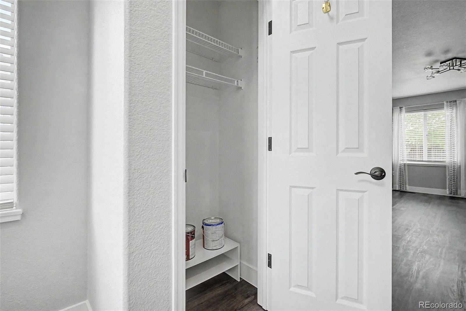 2233 70th Avenue Greeley, CO 80634 - Photo 5 of 50 a view of a hallway with wooden floor and a bathroom