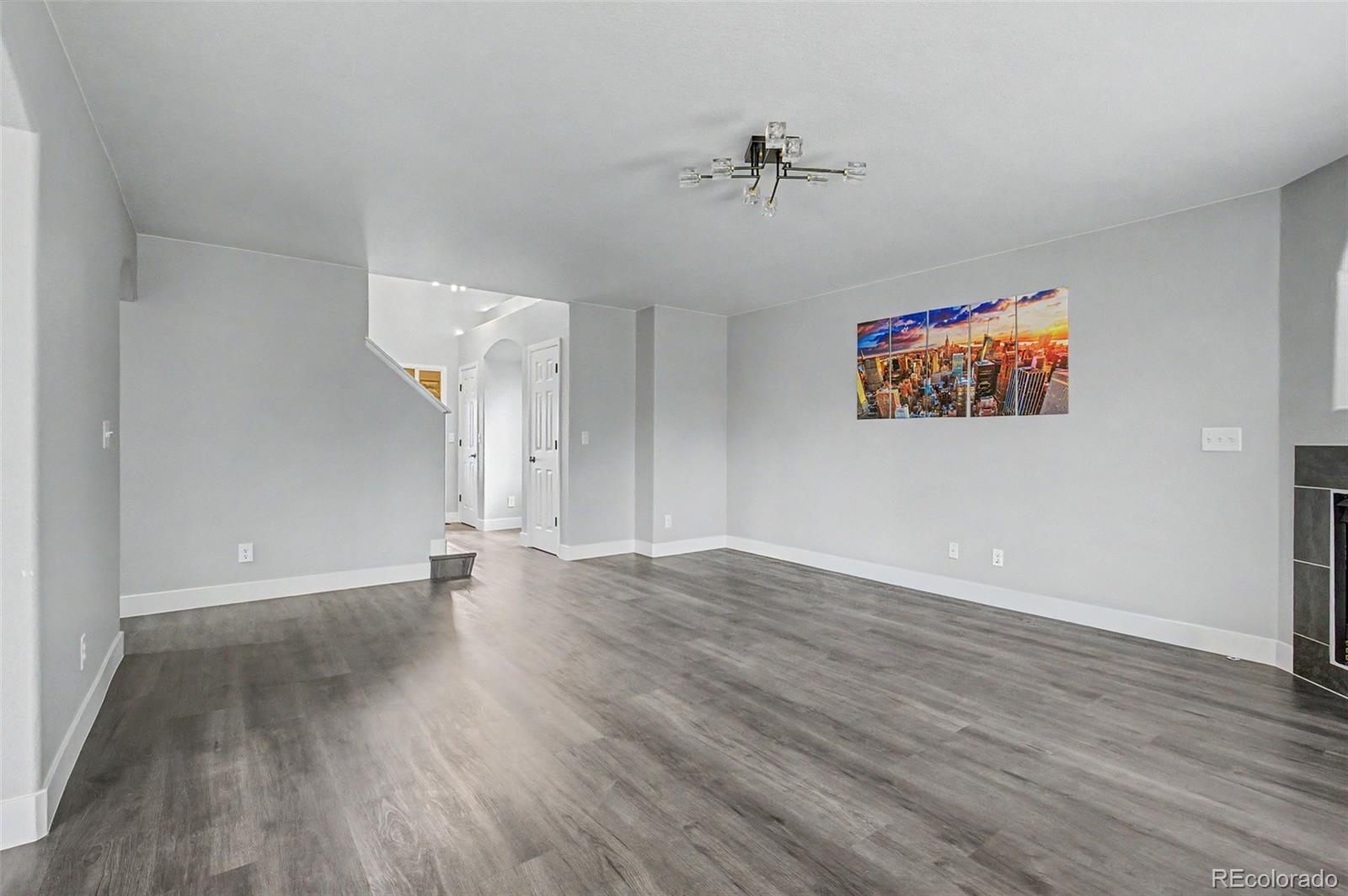 2233 70th Avenue Greeley, CO 80634 - Photo 8 of 50 wooden floor in an empty room with a window