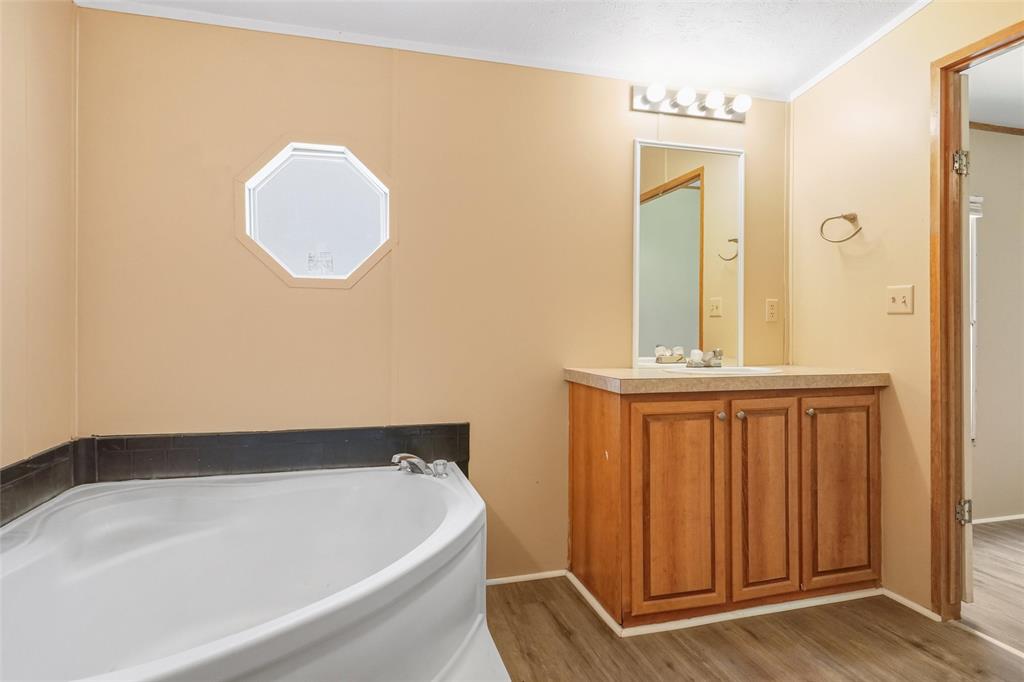 331 Prairie Lane Azle, TX 76020 - Photo 11 of 19 a bathroom with a tub and sink
