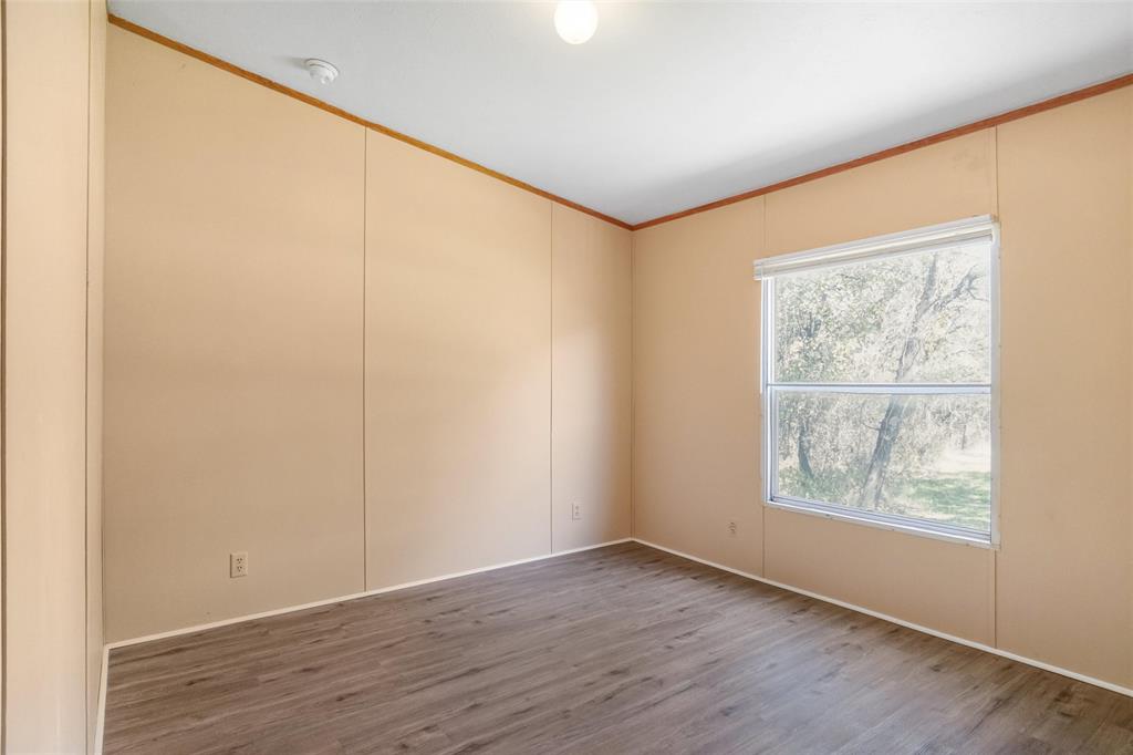 331 Prairie Lane Azle, TX 76020 - Photo 12 of 19 an empty room with wooden floor and windows