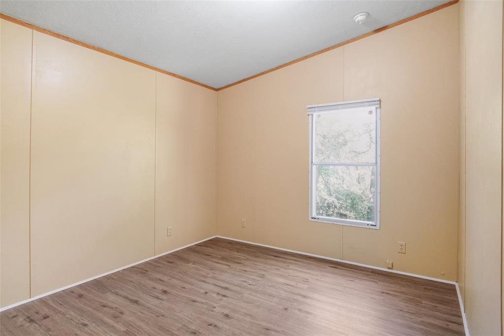331 Prairie Lane Azle, TX 76020 - Photo 13 of 19 an empty room with wooden floor and windows