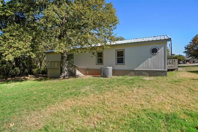 a front view of house with swing and slide