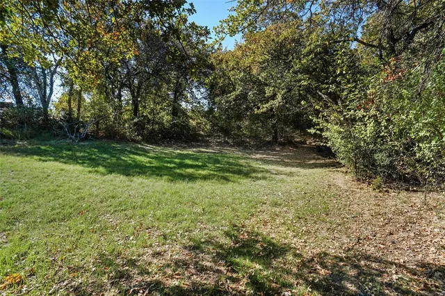 a view of outdoor space with trees all around