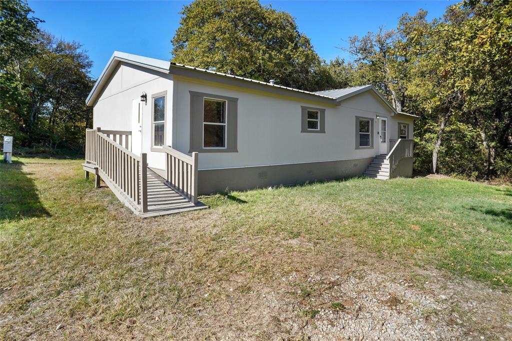 331 Prairie Lane Azle, TX 76020 - Photo 2 of 19 a view of a house with a yard
