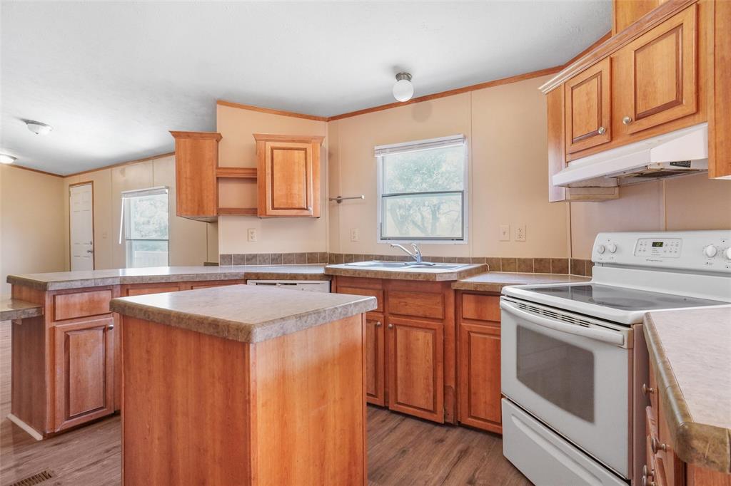 331 Prairie Lane Azle, TX 76020 - Photo 7 of 19 a kitchen with a stove a sink and a refrigerator