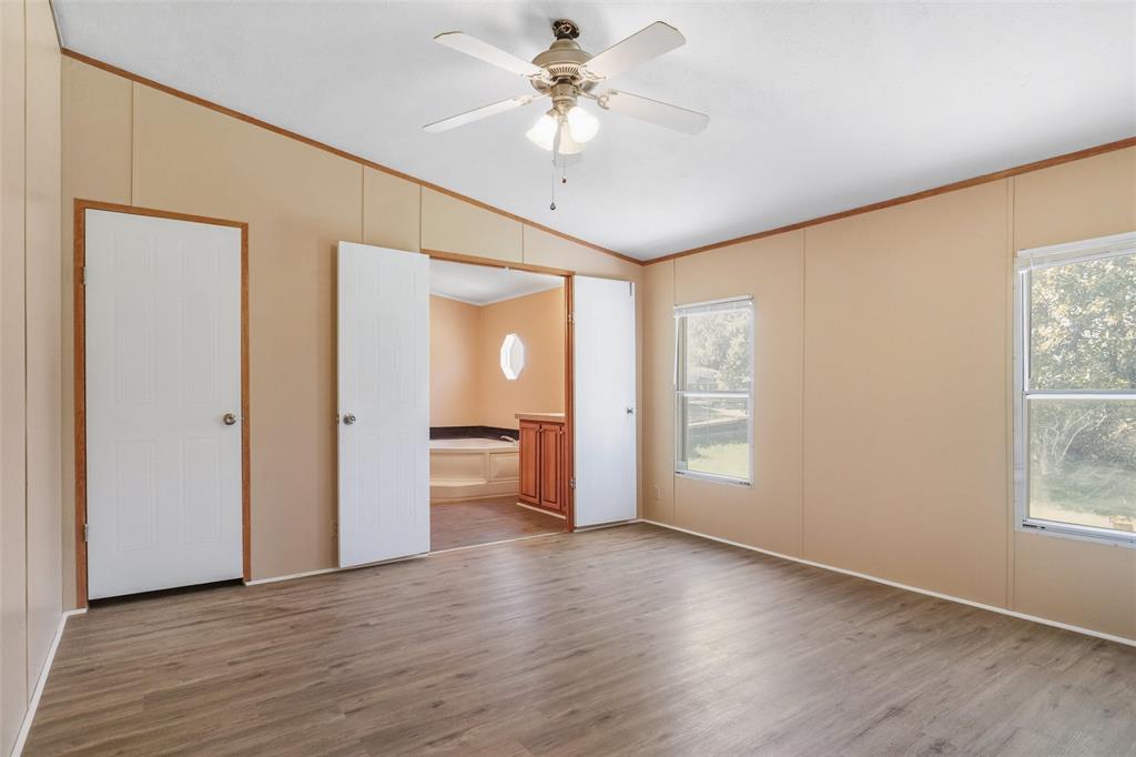 331 Prairie Lane Azle, TX 76020 - Photo 9 of 19 a view of an empty room with a window and wooden floor