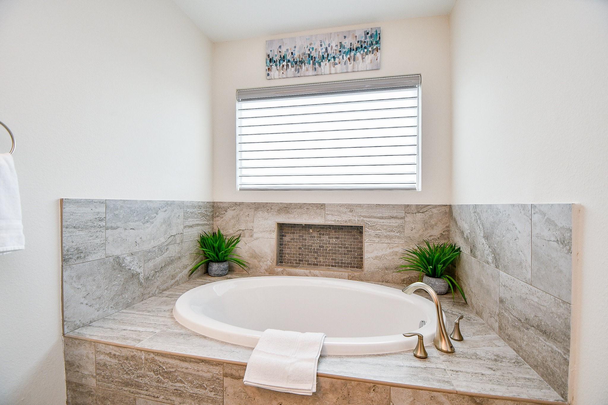 4604 Chartres Street Houston, TX 77004 - Photo 11 of 20 Pure indulgence awaits in the primary en-suite, an oversized garden soaking tub framed by stunning stone tile and a mosaic accent niche creates an absolutely spa-worthy bathing experience. This is the kind of tub you sink into and forget the rest of the world exists!