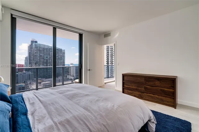 a bathroom with a double vanity sink a mirror and a bathtub