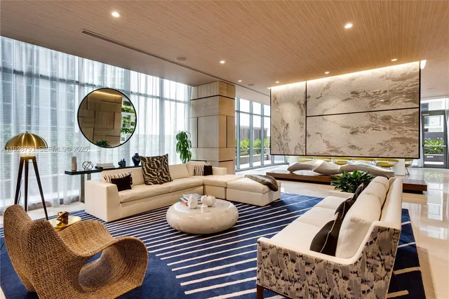 a bathroom with a granite countertop tub and a chandelier