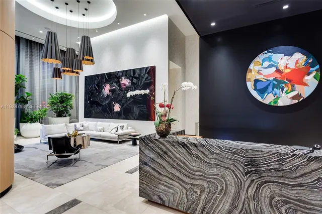 a view of entryway with paintings on the wall