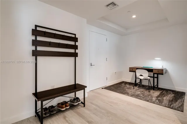 a living room with furniture and a mirror