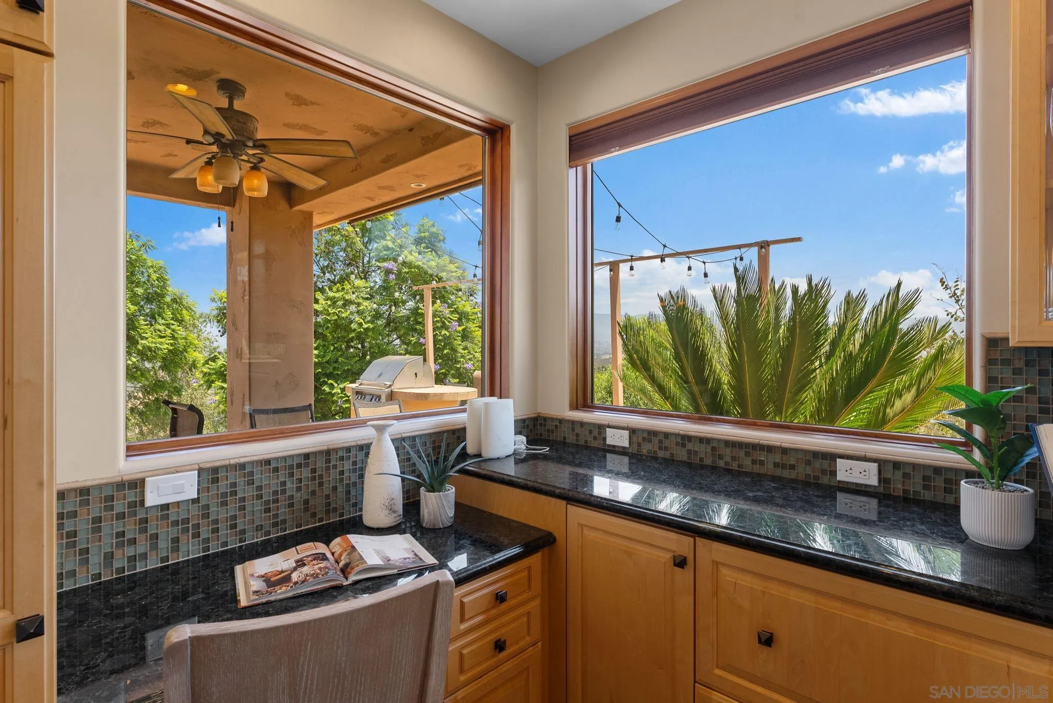 12443 Mirar De Valle Road Valley Center, CA 92082 - Photo 11 of 54 a kitchen with a large window cabinets and stainless steel appliances