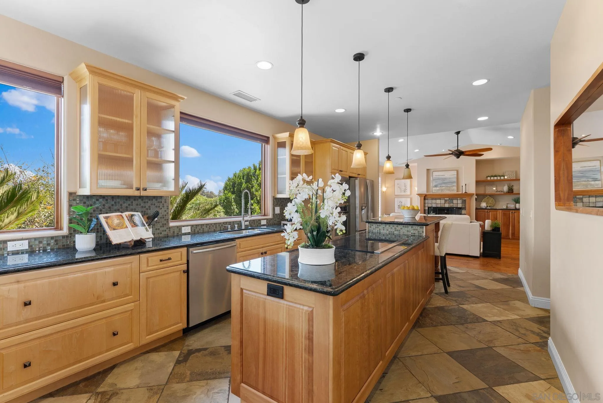 12443 Mirar De Valle Road Valley Center, CA 92082 - Photo 13 of 54 a kitchen with kitchen island granite countertop a sink and counter space