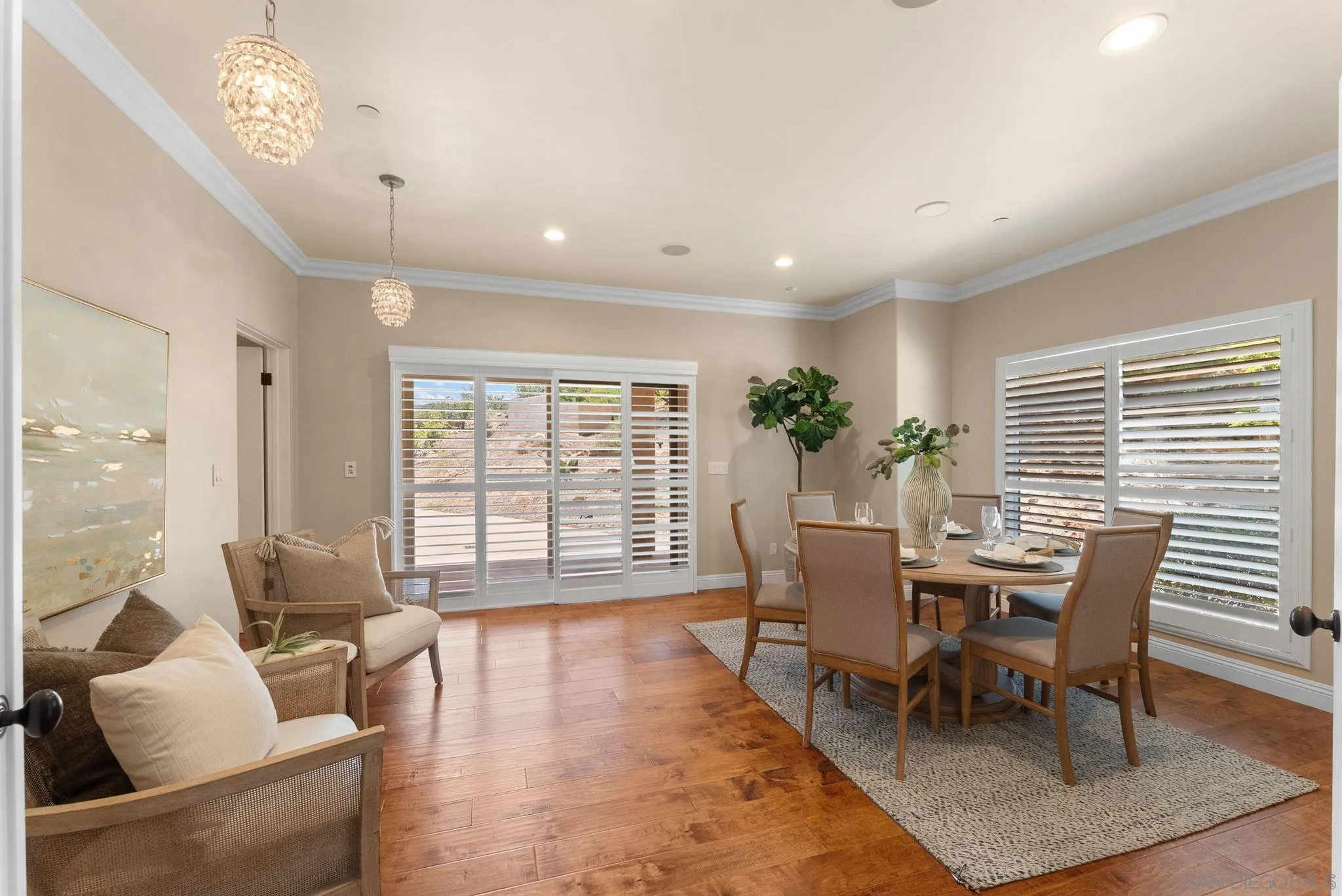 12443 Mirar De Valle Road Valley Center, CA 92082 - Photo 15 of 54 a dining room with furniture potted plants and wooden floor