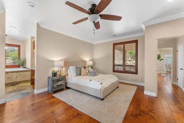 a spacious bedroom with a bed and a dresser