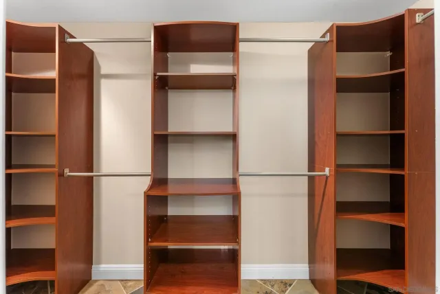 a view of walk in closet with empty racks
