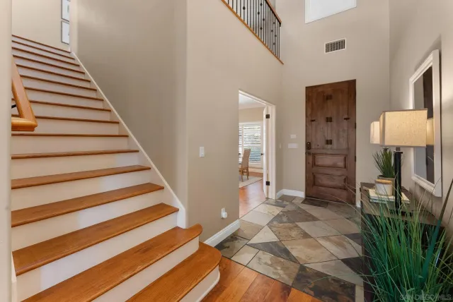 a view of a hallway with wooden floor and entryway