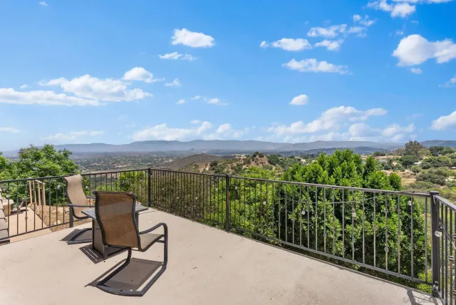 a view of a chairs and table in the balcony