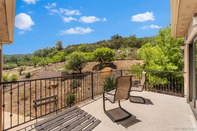 a view of a chairs and table in the balcony