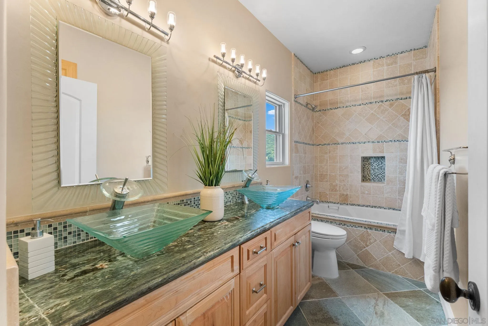 12443 Mirar De Valle Road Valley Center, CA 92082 - Photo 31 of 54 a bathroom with a granite countertop sink a toilet and a mirror