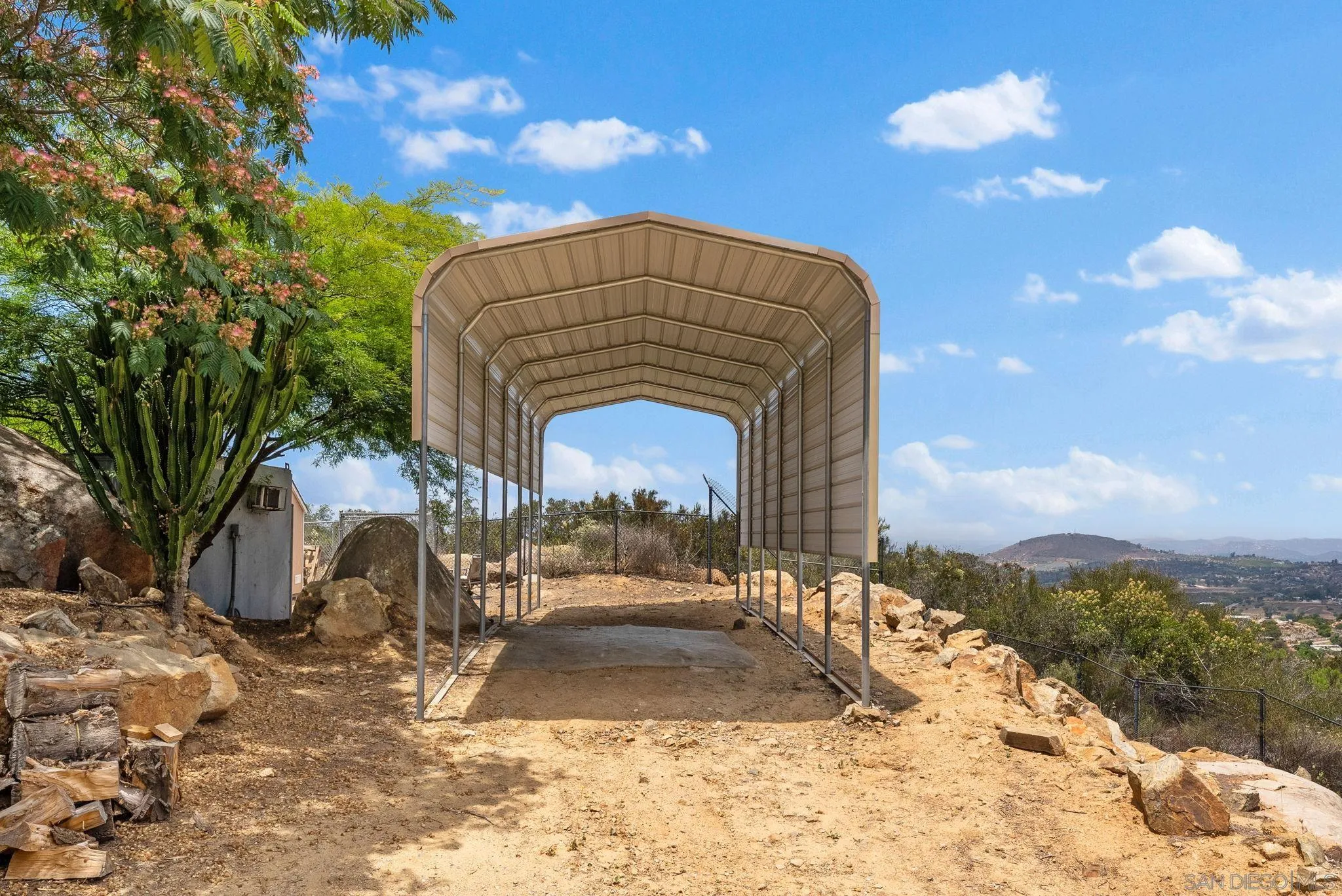 12443 Mirar De Valle Road Valley Center, CA 92082 - Photo 40 of 54 a view of a house with a yard