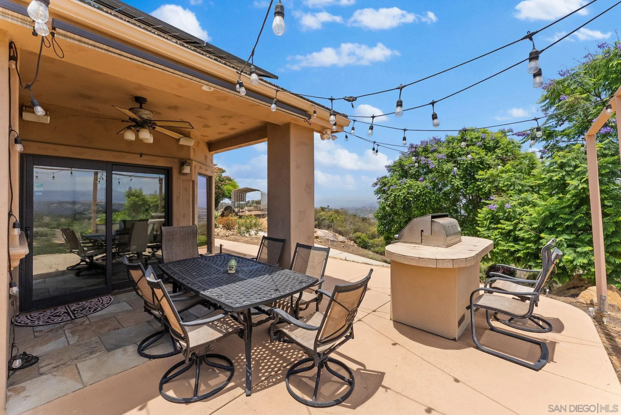 12443 Mirar De Valle Road Valley Center, CA 92082 - Photo 42 of 54 a view of a patio with table and chairs and potted plants