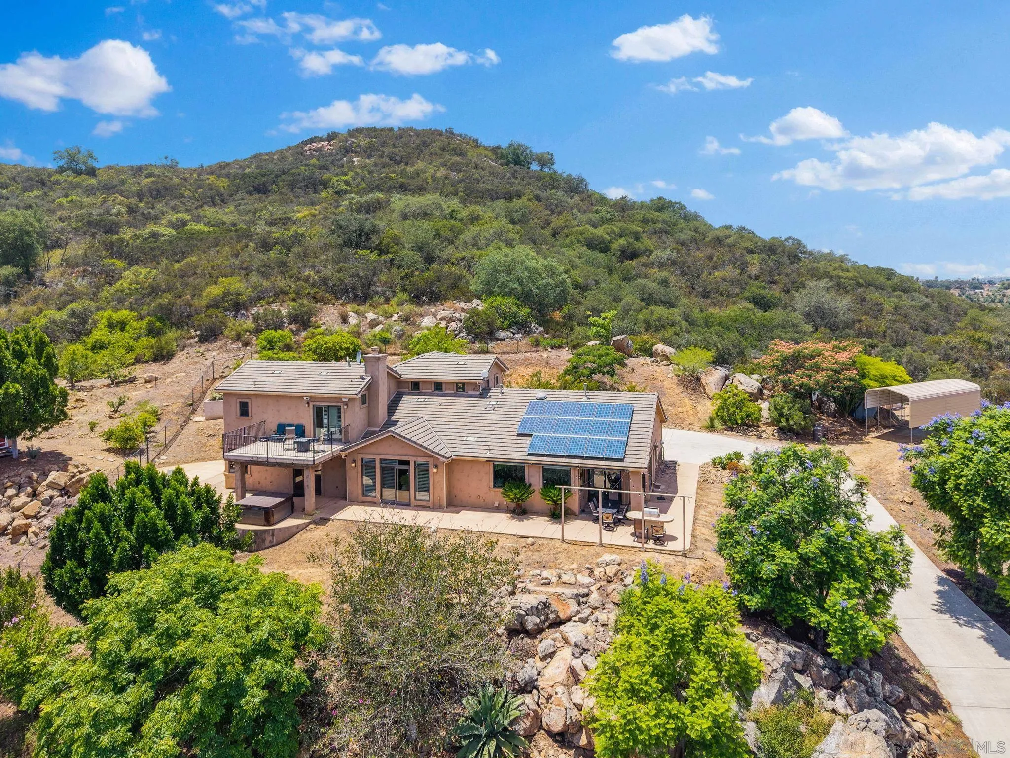12443 Mirar De Valle Road Valley Center, CA 92082 - Photo 49 of 54 an aerial view of a house with a mountain in the background