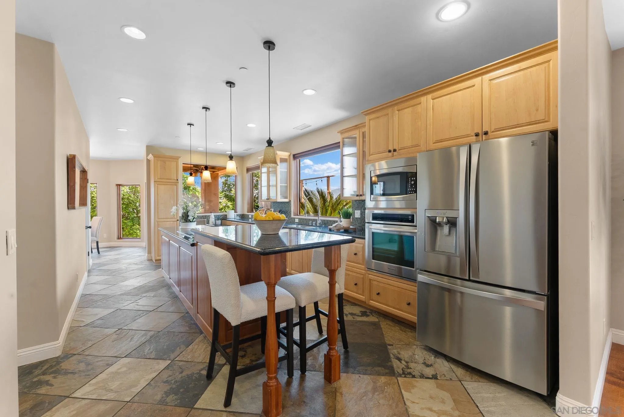 12443 Mirar De Valle Road Valley Center, CA 92082 - Photo 8 of 54 a kitchen with stainless steel appliances a refrigerator and a stove top oven