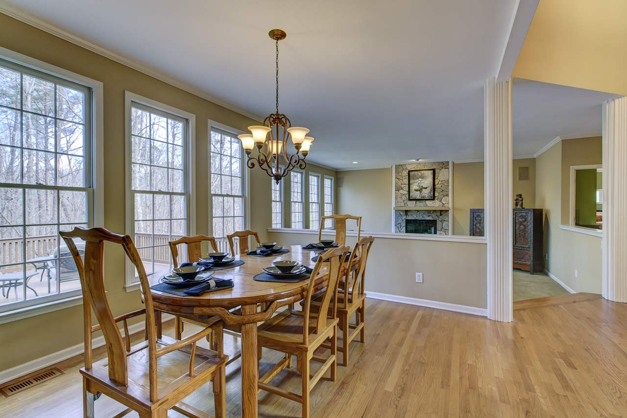 12312 Galway Drive Raleigh, NC 27613 - Photo 5 of 25 The dining room is grounded with hardwood floors and showcases a chandelier and wall of windows. Dining Room