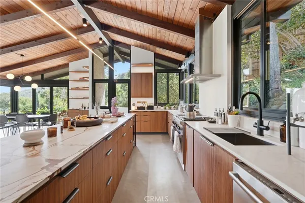 a kitchen with lots of counter top space a sink and a large window