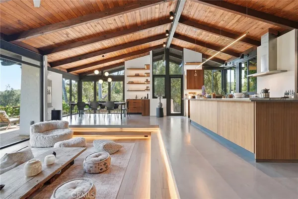 a view of a living room and kitchen with a large window