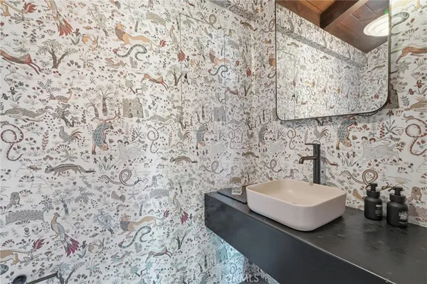 a bathroom with a sink and mirror