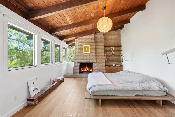 a bedroom with bed and a chandelier