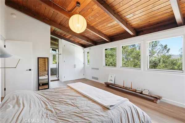 a bedroom with a bed and a large window