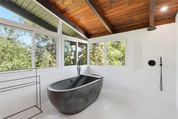 a bathroom with a bathtub and window