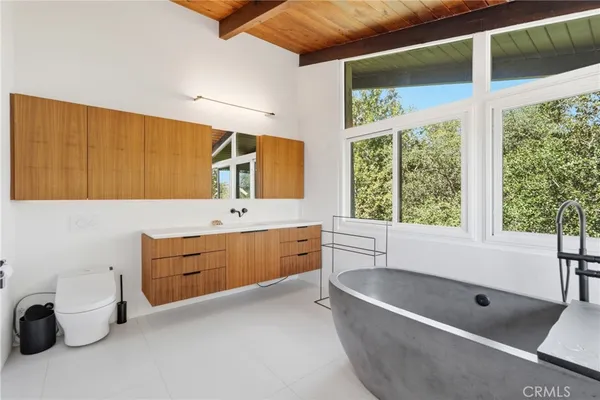 a bedroom with a large bed and a large window