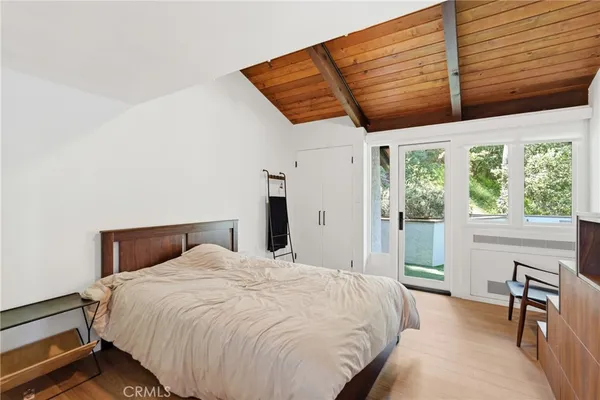 a bed sitting in a bedroom next to a window