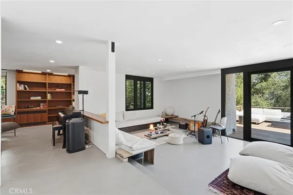 a living room with furniture and a floor to ceiling window