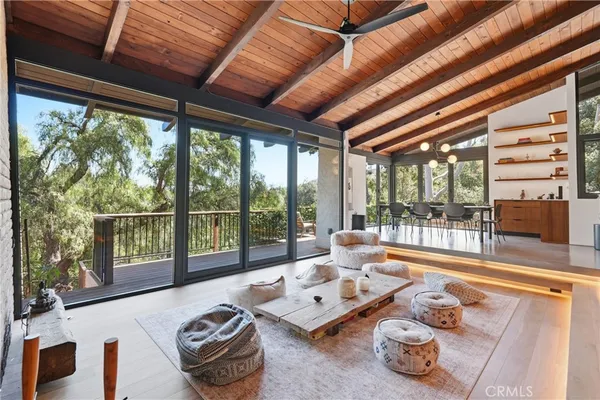 a living room with furniture and a floor to ceiling window
