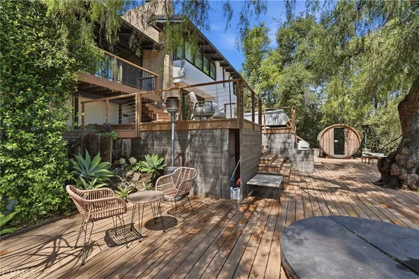 a balcony with furniture and a potted plant
