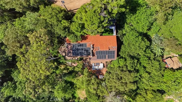 a view of a house with a mountain and a forest